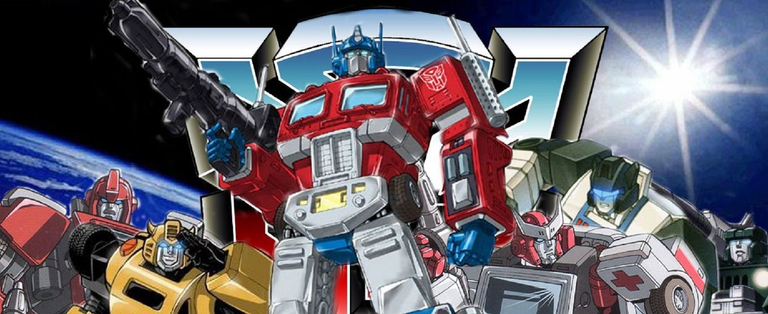 A promotional image for the 1984 television series “The Transformers”, based on a series of children’s toys that transformed from cars and trucks into robots. In the image the giant transforming robot Optimus Prime holds a large futuristic rifle; he is surrounded by fellow Transformers.