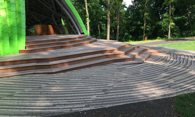 Pervious clay pavers forming the pedestrian area in front of the Chrysalis stage. (Click for a higher-resolution version.)  To the upper right is the walkable access road leading to the Chrysalis from the Merriweather Post Pavilion VIP parking lot. In the background is the beta stage. (See also the figure below.)  Image © 2017 Inner Arbor Trust; used with permission.